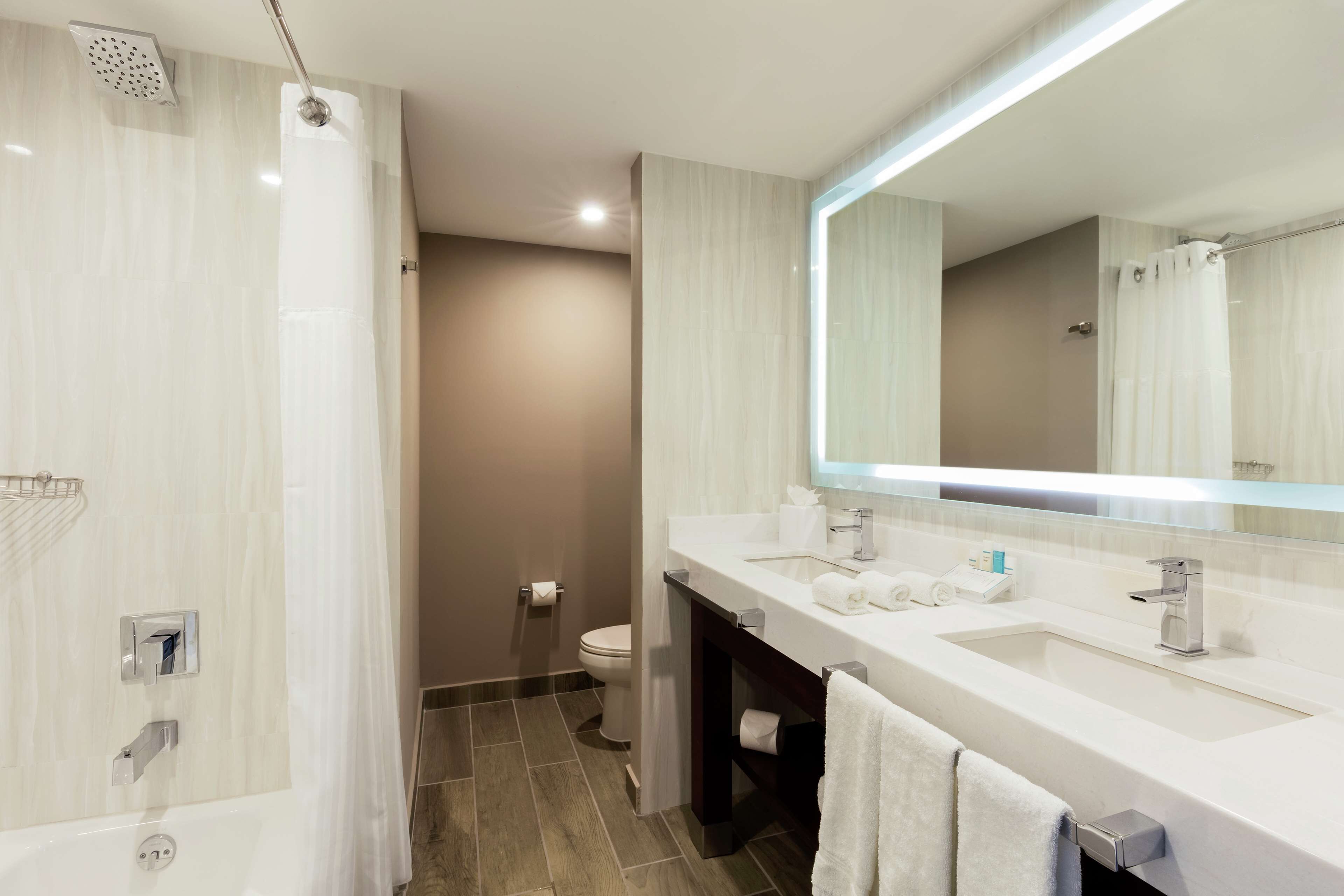 combined shower/bathtub, designer toiletries, hair dryer, towels