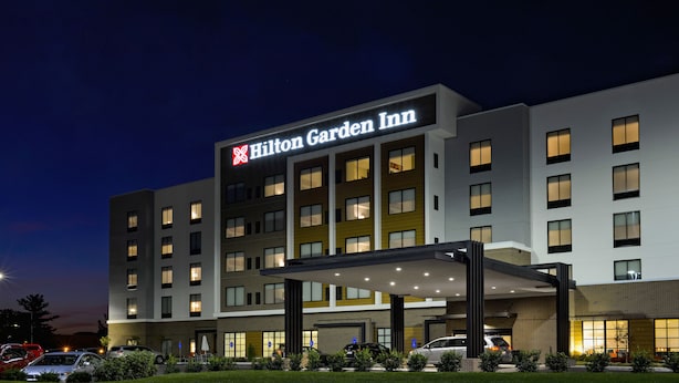 A Hilton Garden Inn hotel with a modern design, multiple floors, and a well-lit entrance. - Hilton Garden Inn Louisville Mall of St. Matthews (Louisville)