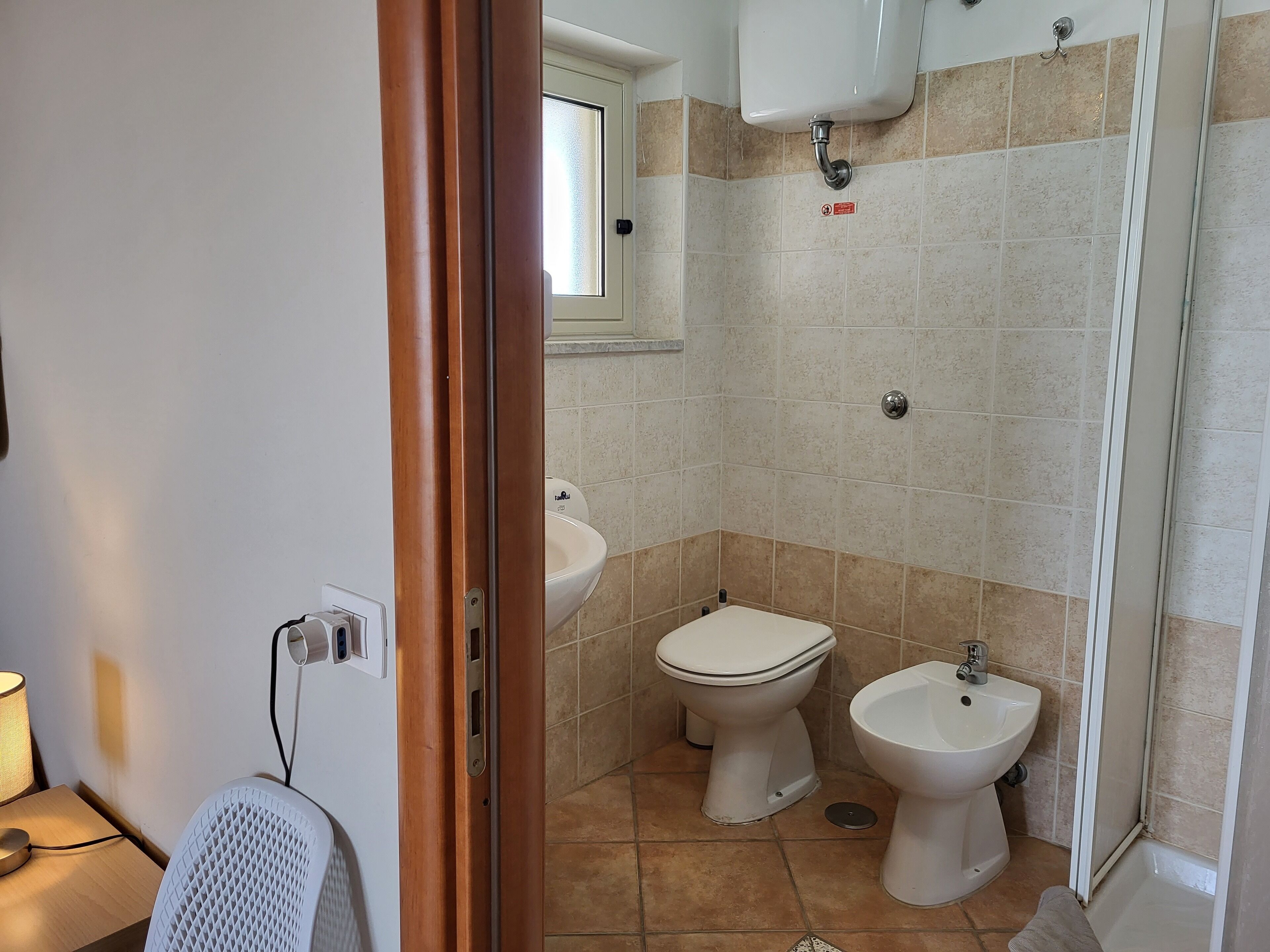 Un bagno con il water, un bidet e uno spazio doccia.