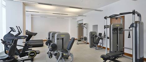 A gym with treadmills, weight machines, and free weights.