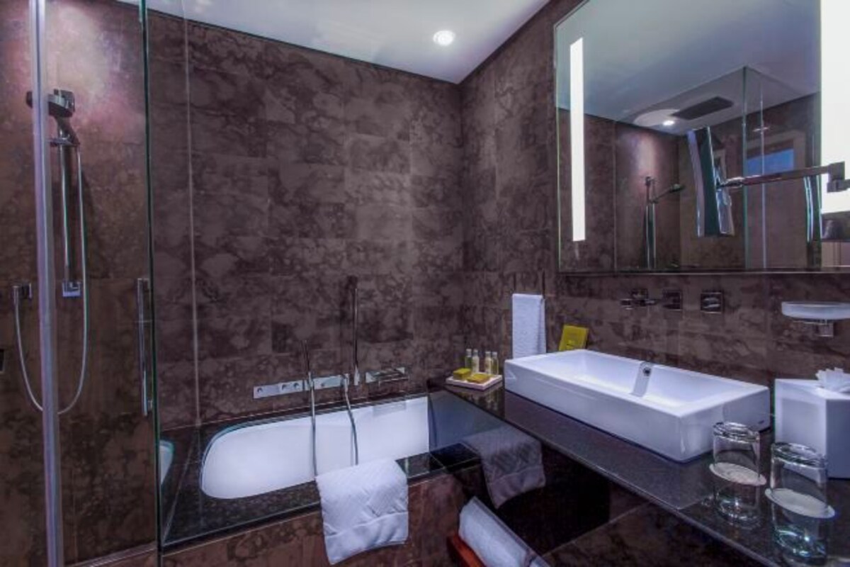 Separate tub and shower, designer toiletries, hair dryer, bathrobes