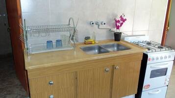 Full-sized fridge, stovetop, cookware/dishes/utensils