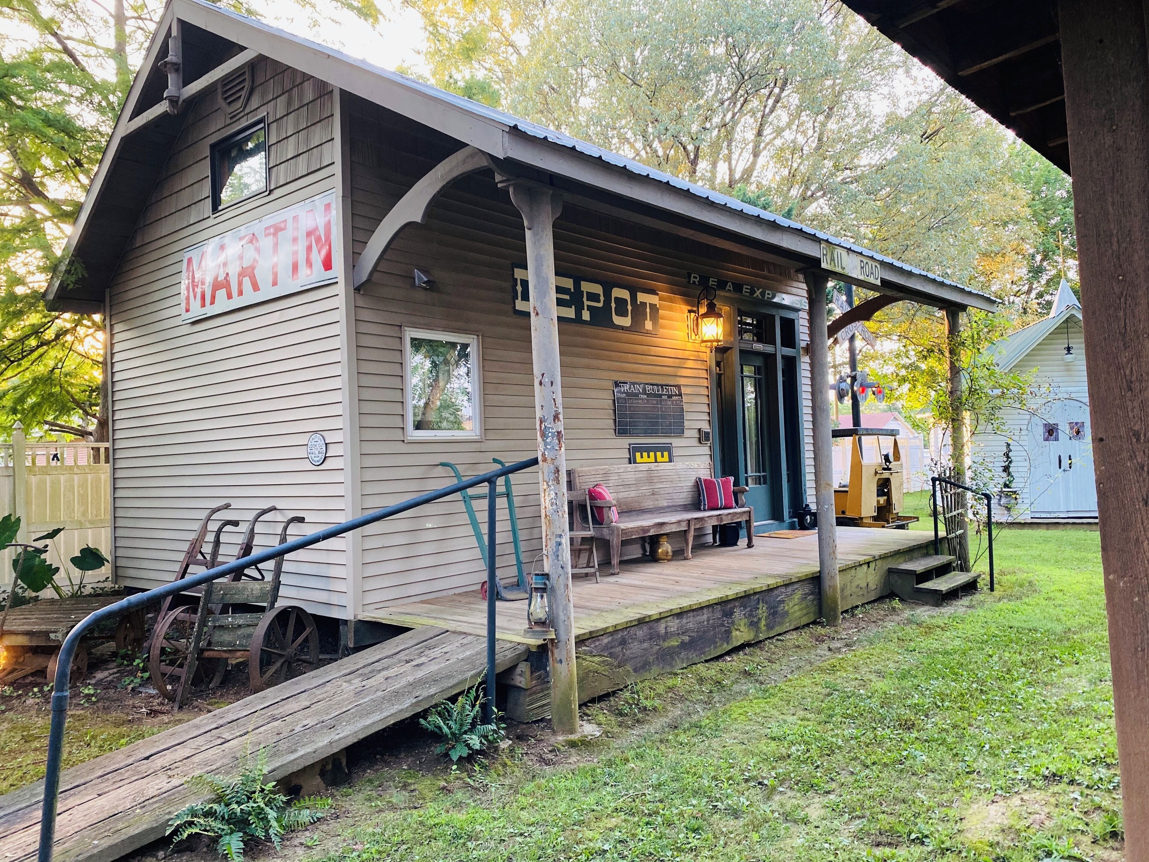 A small, single-story building with a porch, a bench, and a sign that reads "MARTIN'S".