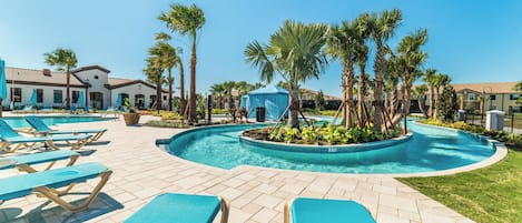 A pool area with lounge chairs and palm trees.