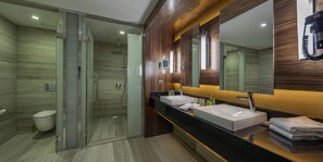 A modern bathroom with a glass-enclosed shower, two sinks, and a large mirror. - DoubleTree by Hilton Istanbul Topkapi (Istanbul)