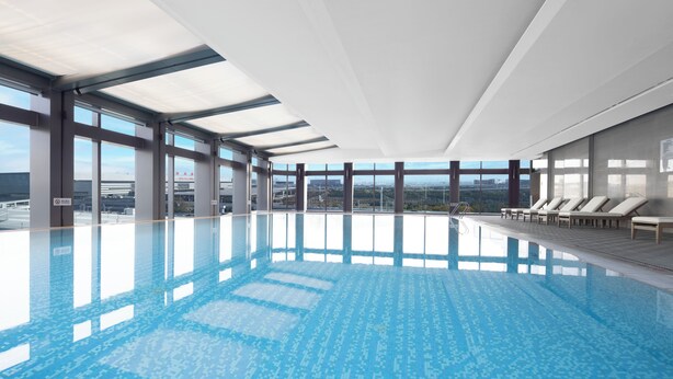 A large indoor swimming pool with clear views of the cityscape through large windows. - Hyatt House Shanghai Hongqiao CBD (Shanghai)