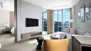 A modern hotel room with a large window, a flat-screen TV, a sofa, a dining table, and a chair. - Hyatt House Shanghai Hongqiao CBD (Shanghai)