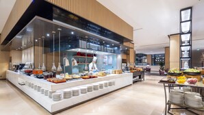 A modern buffet setup with a chef preparing food, a variety of dishes, and a clean, contemporary interior. - Hyatt House Shanghai Hongqiao CBD (Shanghai)