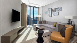 A modern hotel room with a large window, a flat-screen TV, a sofa, a coffee table, a chair, and artwork on the walls. - Hyatt House Shanghai Hongqiao CBD (Shanghai)