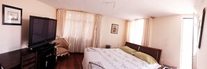Deluxe Suite, 1 King Bed, Private Bathroom | Desk, iron/ironing board, free WiFi, bed sheets