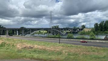 A bridge over a river with a road running parallel to it.