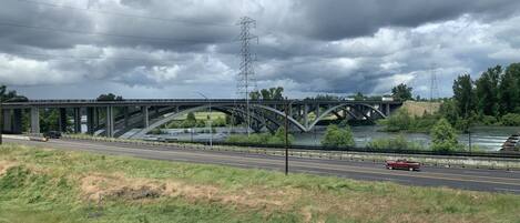 A bridge over a river with a road running parallel to it.