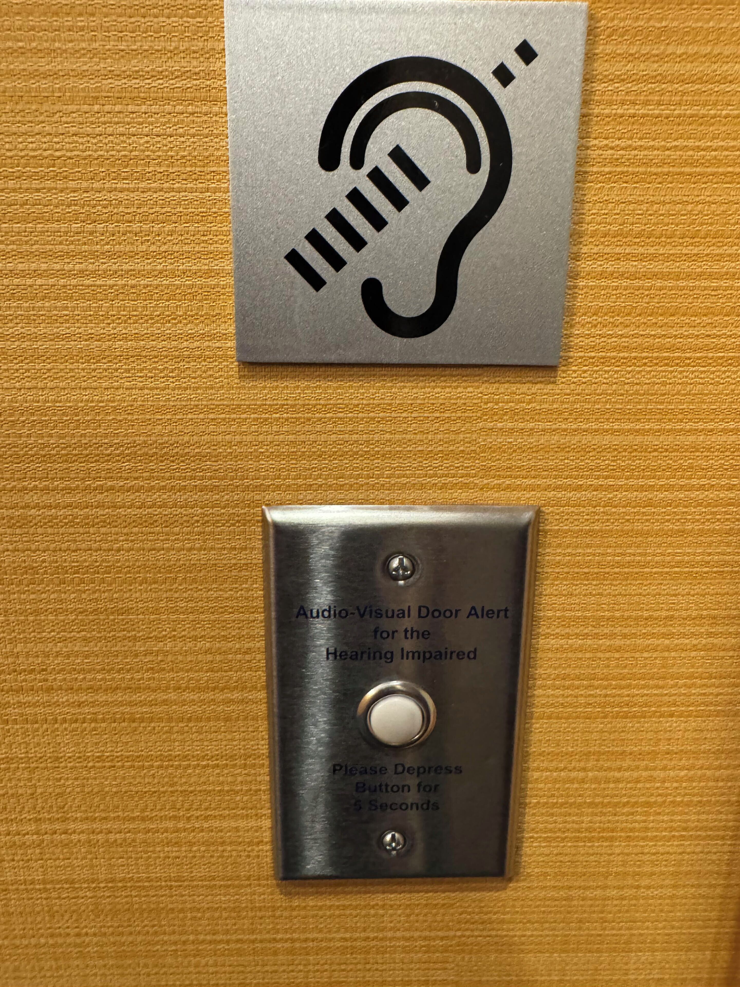 A doorbell with an audio-visual alert for the hearing impaired and a button to depress for 5 seconds.