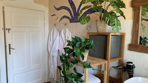 A bathroom with a white door, a wooden shelf with plants, a white sink, and a mirror. - Beautiful old building apartment in a top location 10 minutes to town in the residential area (Biederitz)