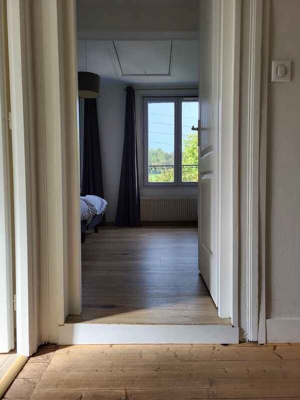 A room with a bed, a window, and a radiator.