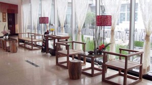 A spacious lobby with wooden chairs and tables, large windows with sheer curtains, and a view of greenery outside. - S&N Niutoushan Resort (Taizhou)