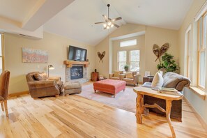 A spacious living room with a fireplace, leather furniture, and large windows. - BEST Location Park City: Walk In Out Ski. Town, Trails, Garage (PARK CITY)