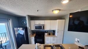 A kitchen with a refrigerator, microwave, stove, and sink. - THE BEST!!  100% Newly Renovated  CLEAN! And The VIEWS!!   (Myrtle Beach)