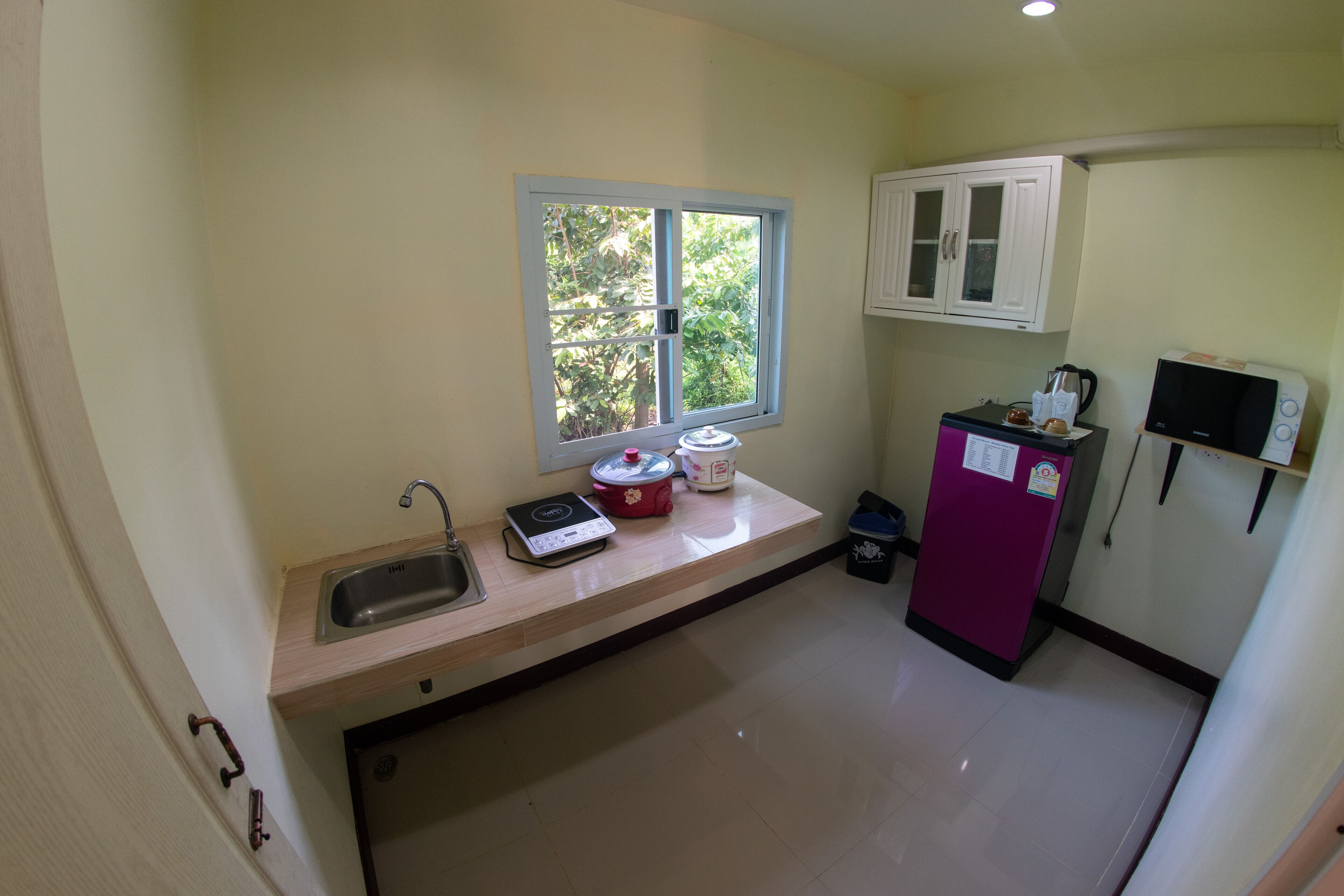 junior suite, 1 king bed, kitchenette, garden area | private kitchenette | mini-fridge