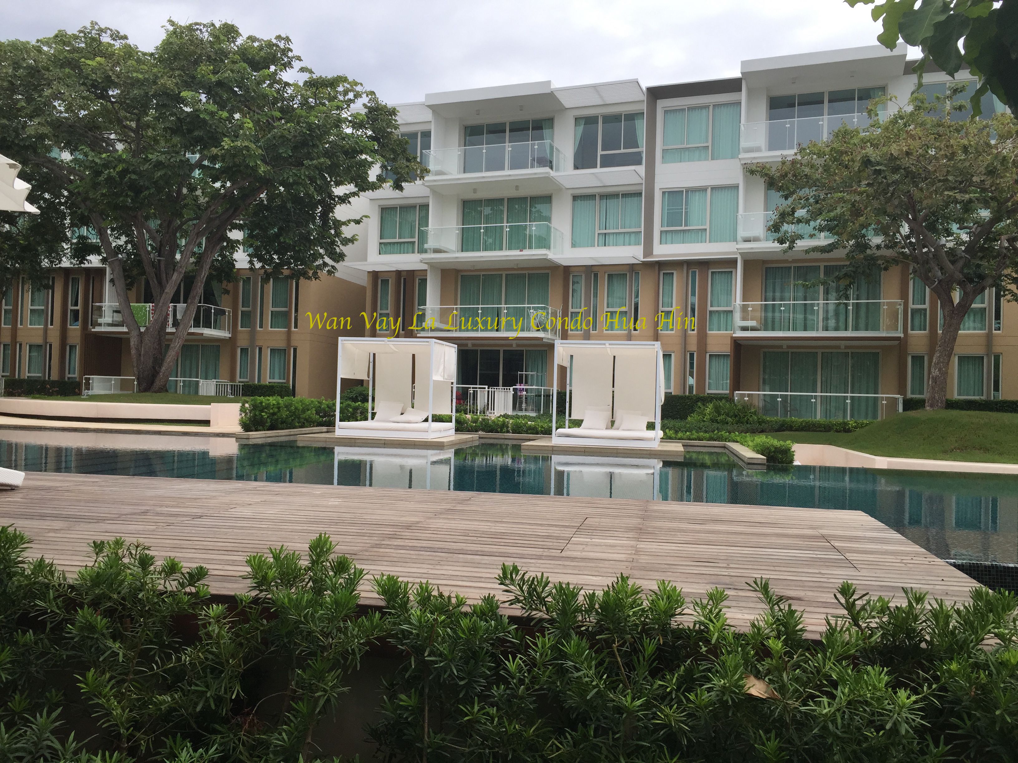 A modern building with a pool and outdoor seating.