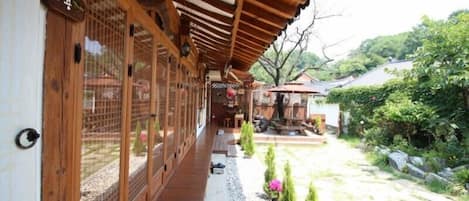 Un edificio de madera tradicional con puertas correderas y un corredor cubierto.