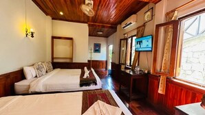 A hotel room with two beds, a wooden ceiling, a TV, and a large window. - Villa Kingkham Riverside (Luang Prabang)