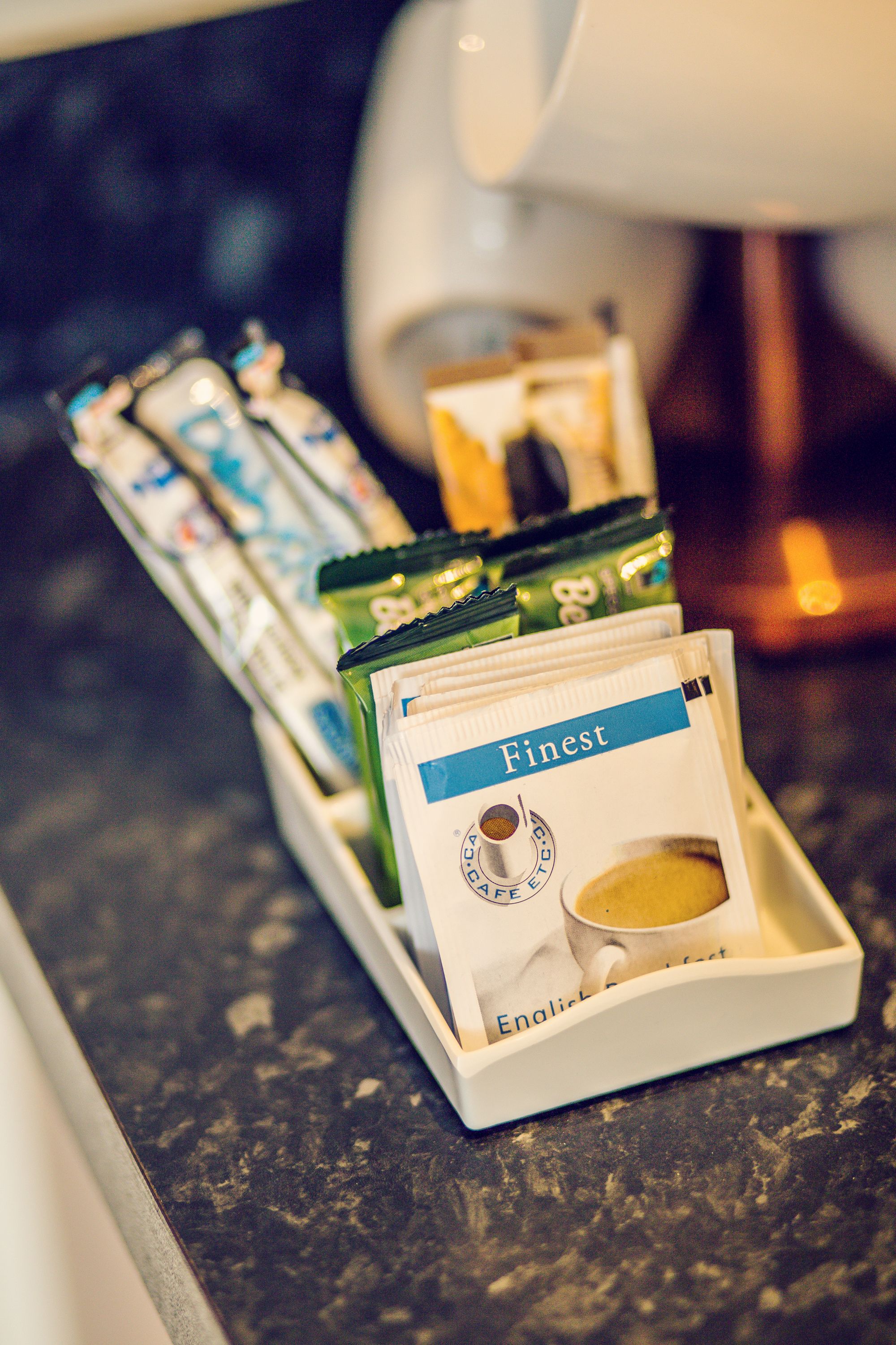A coffee machine with a tray holding several coffee pods.