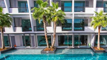 Een buitenzwembad, parasols voor strand/zwembad