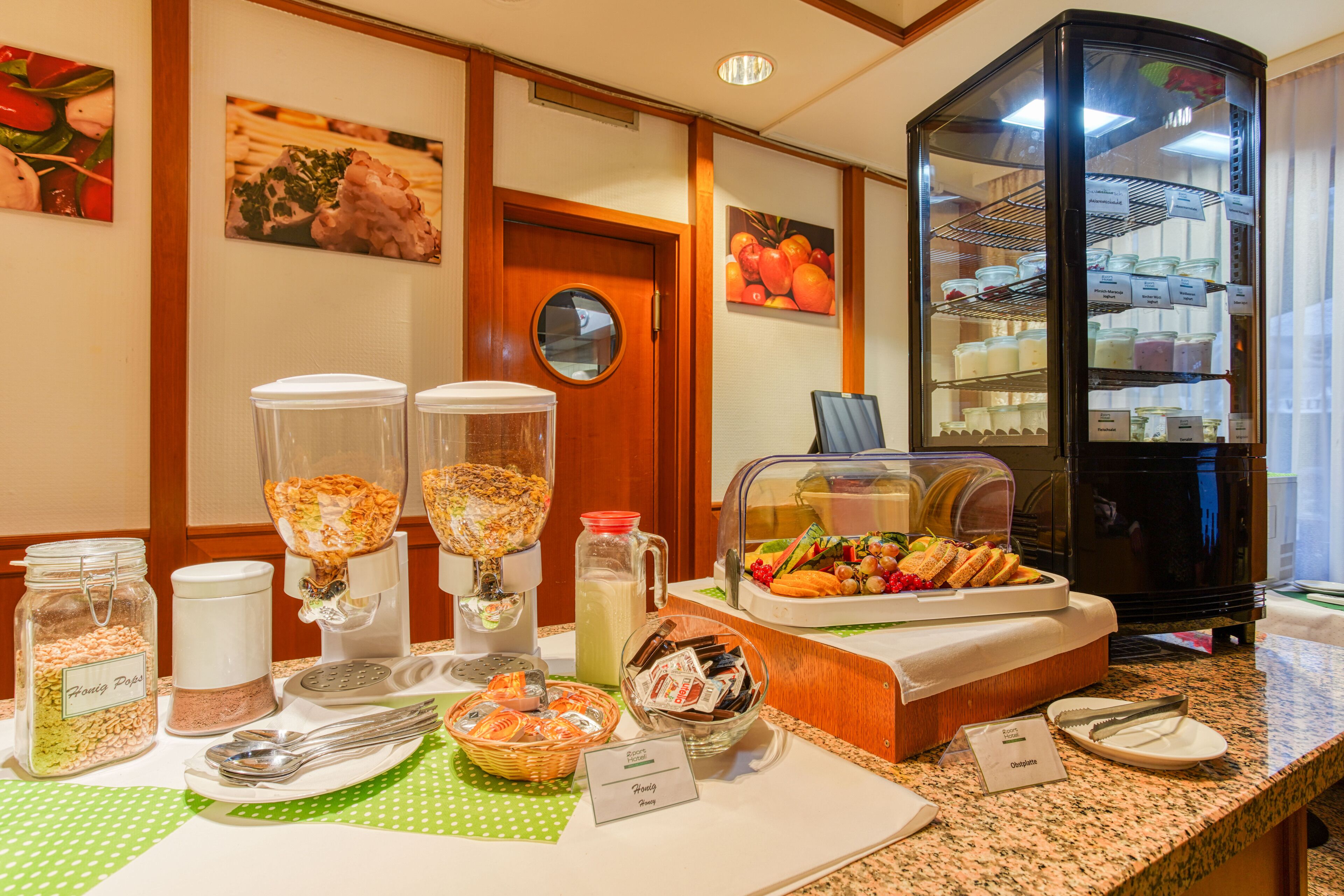 A breakfast buffet setup with various food items and condiments.
