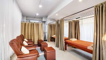 Relax in a spacious room with a large bed, seating area, and ample natural light.