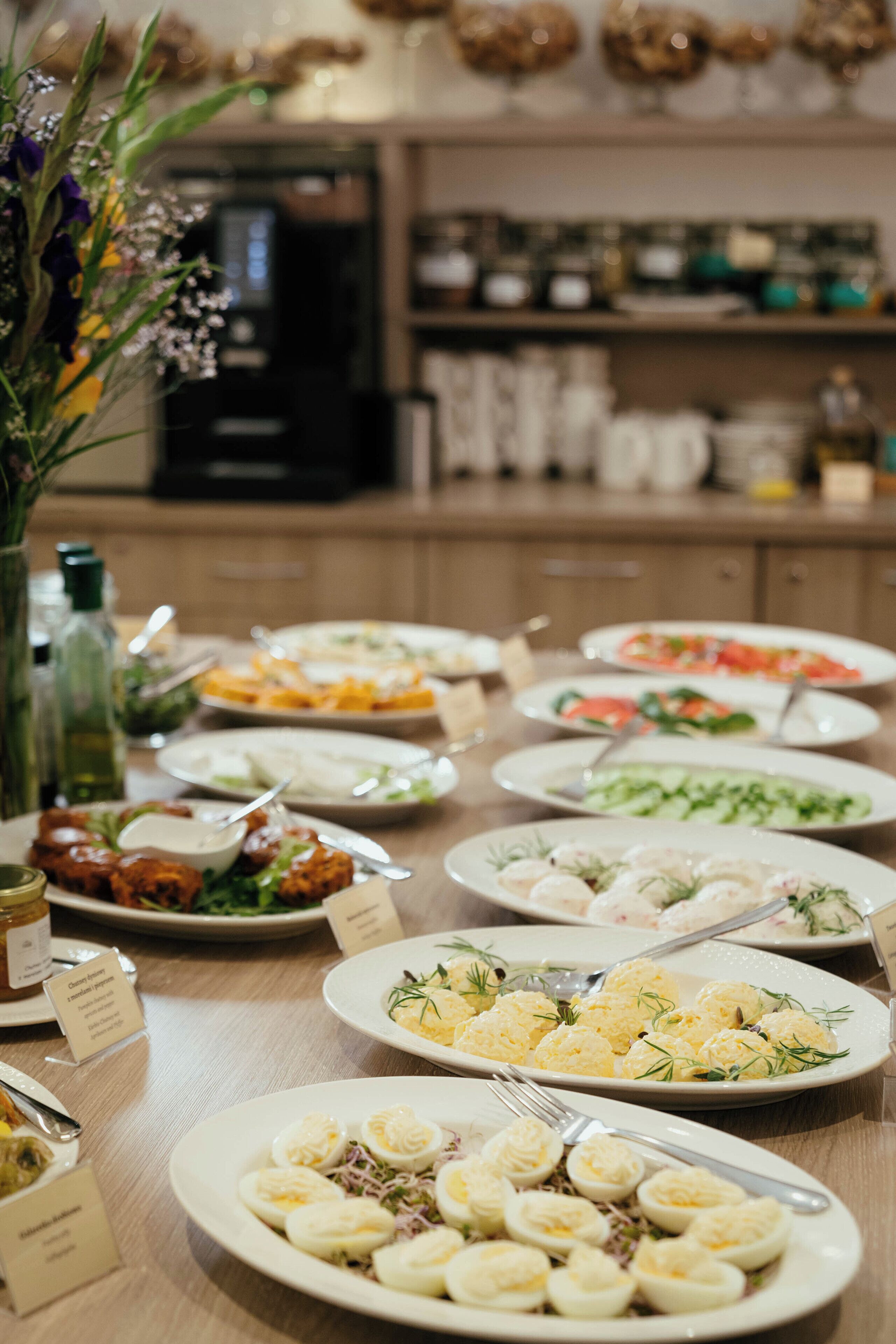 A buffet table with various dishes, including salads, eggs, and other appetizers.