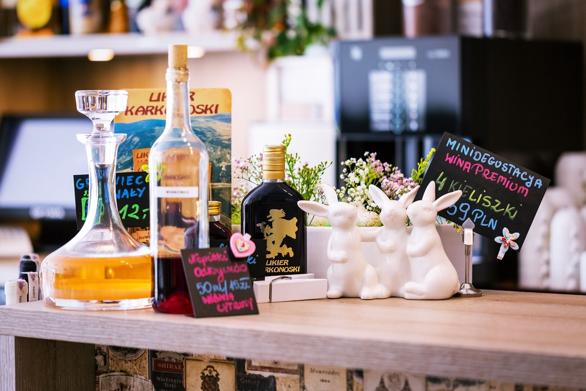 A bar area with various bottles and a chalkboard sign.