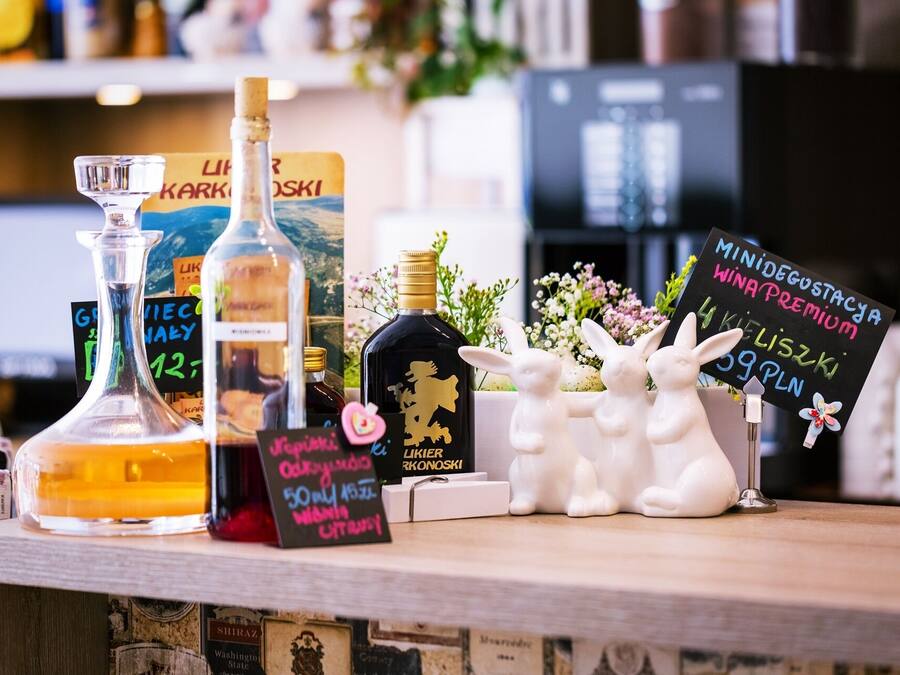 A bar area with various bottles and a chalkboard sign.