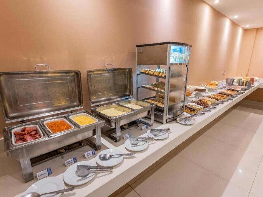 A buffet setup with various food items and utensils.