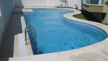 Outdoor pool, open 10 AM to 8 PM, pool umbrellas, pool loungers