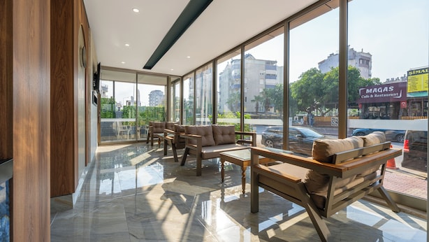 Un intérieur moderne avec de grandes fenêtres, des meubles en bois et un sol carrelé, sobre et élégant.