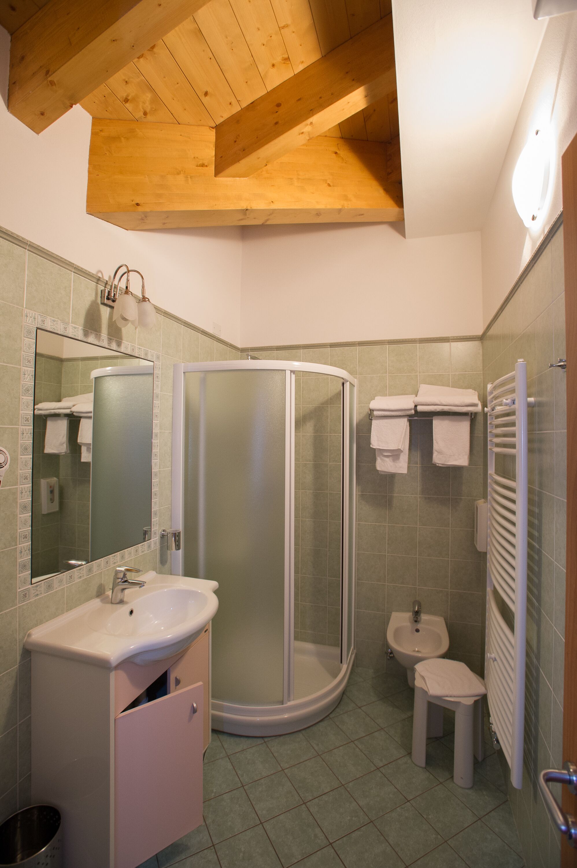 A bathroom with a shower, sink, and toilet.