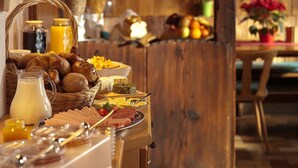 A breakfast buffet with bread, pastries, cheese, and meats. - Hotel Bezzi (Ponte di Legno)