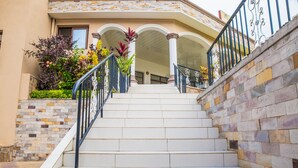 A set of white stairs with black railings leading to a building entrance. - Mountain's View Hotel (Bujumbura)