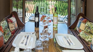 A dining table set for two with a scenic view of a forested hillside. - The Olive Tree Studios - Adults Only (Fethiye)