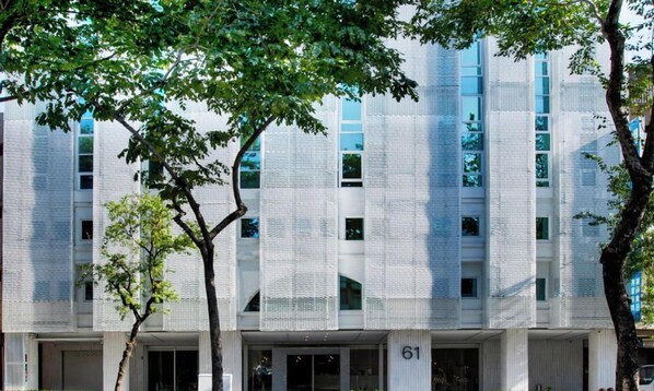 A modern building with a textured facade and multiple windows. - The Carlton (Taichung)