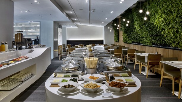 A buffet setup with various food items and a modern interior design. - The Carlton (Taichung)