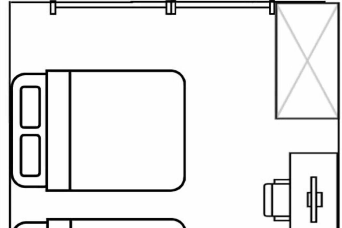 A floor plan with two bedrooms, a bathroom, a kitchen, and a small living area.