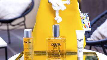 A tray with three bottles of CARITA Paris skincare products.