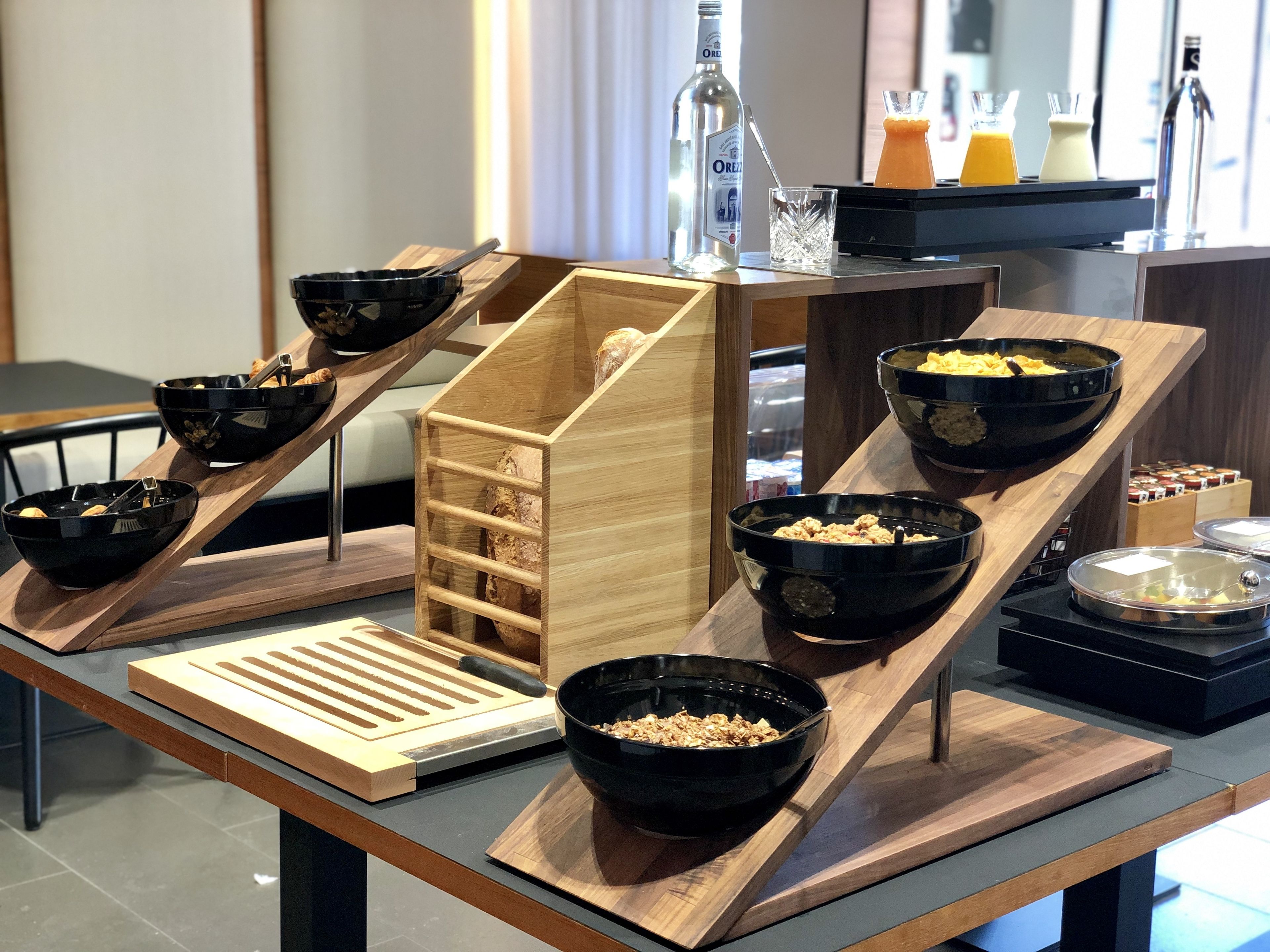 A breakfast buffet setup with various food items and condiments.