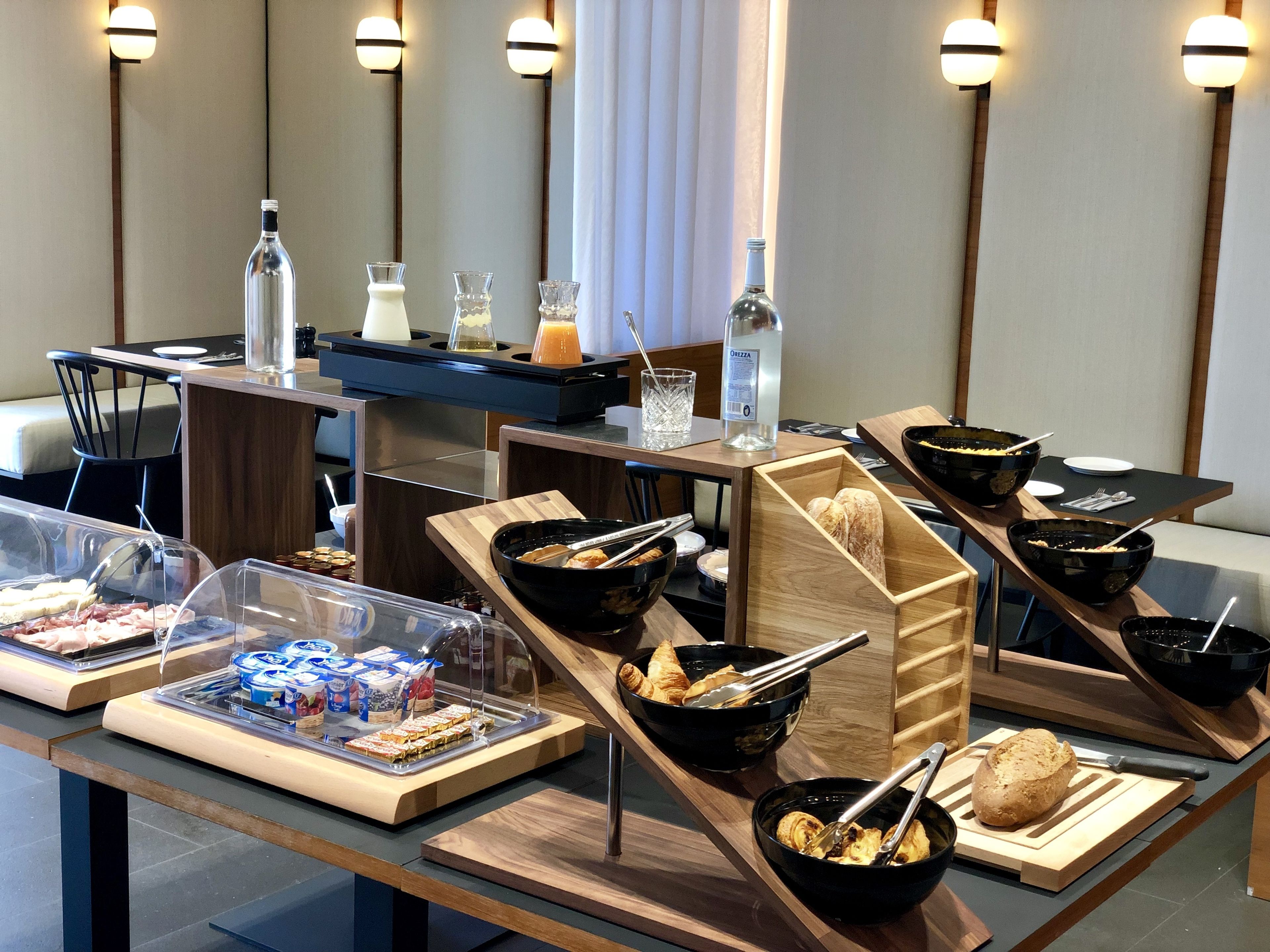 A buffet setup with various food items and beverages.