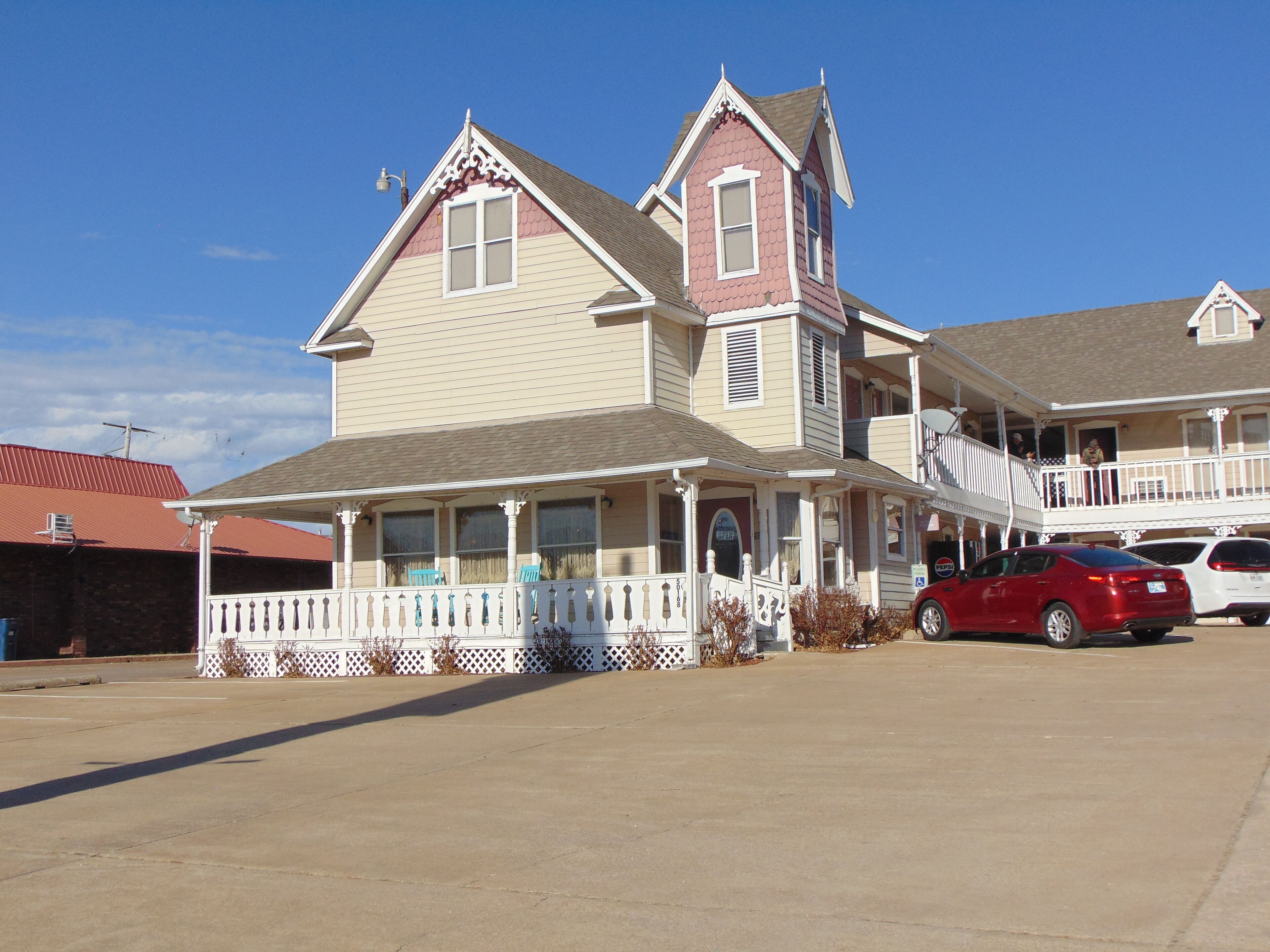 A two-story house with a porch and a garage.