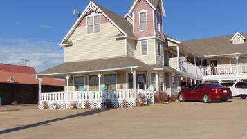 A two-story house with a porch and a garage.