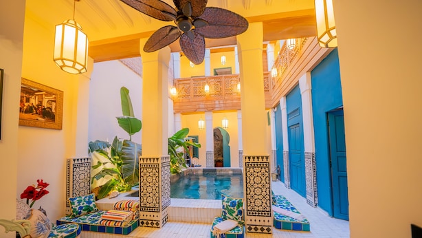 A pool area with a ceiling fan, tiled flooring, and a view of the pool. - Riad Tibibt (Marrakech)