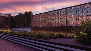A modern building with a geometric facade and a series of steps leading up to it. - Holiday Inn Express Bangkok Soi Soonvijai by IHG (Bangkok)